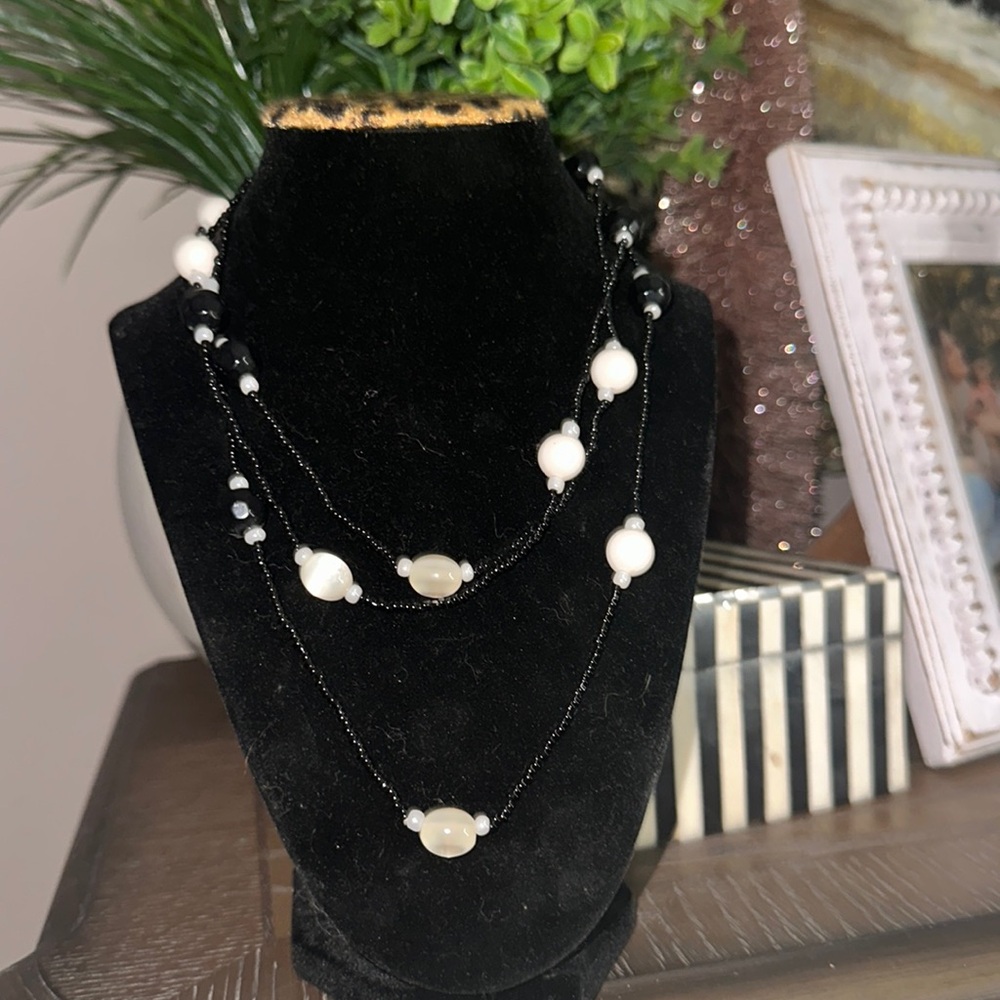 Long black beaded with plastic or glass Pearl like beads can wear long or short